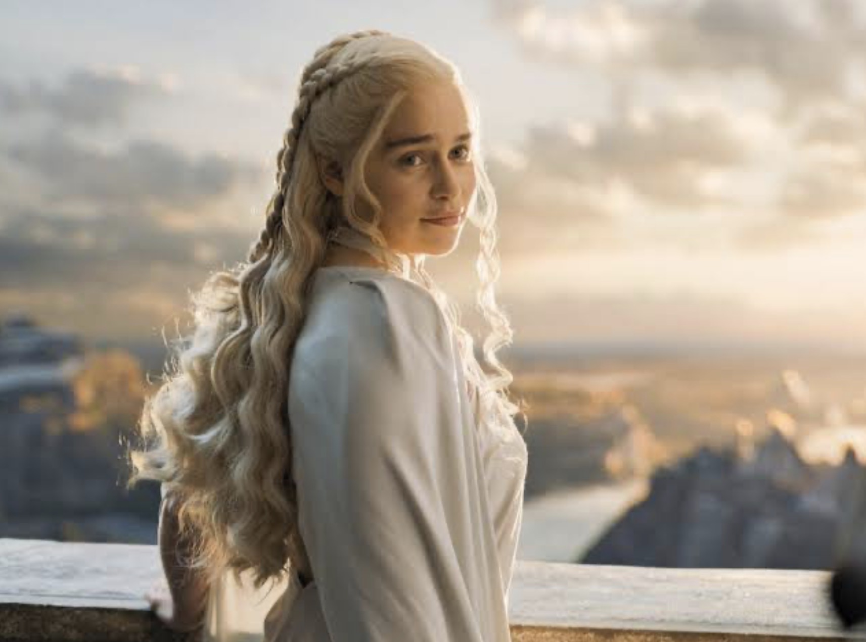 Emilia Clarke as Daenerys Targaryen looking back over her shoulder on a stone balcony